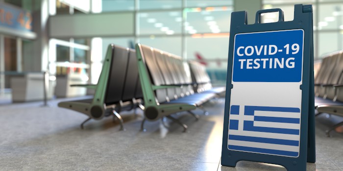 covid-19 testing sign at a greek airport waiting area