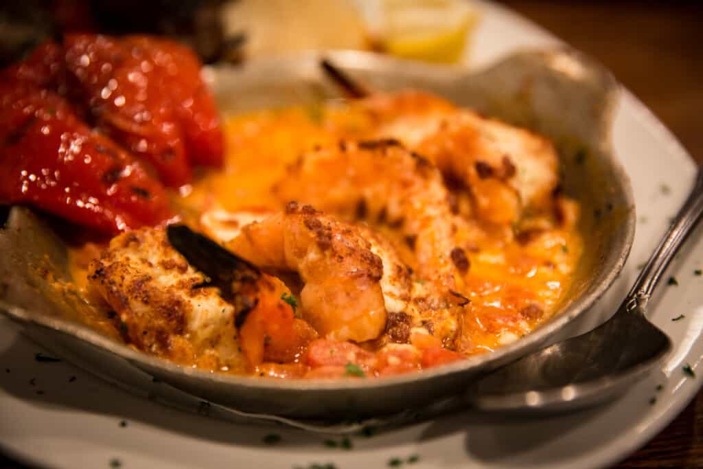 shrimps on red sauce with feta cheese, served in a cast iron pan